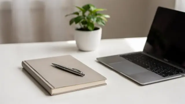 Arbeitsplatz eines Unternehmers mit Laptop, Notizbuch und Pflanze zum Thema Resilienz für Unternehmer